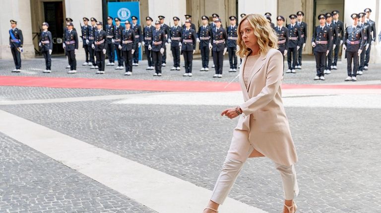 Italy's Prime Minister Giorgia Meloni walks before her meeting with...