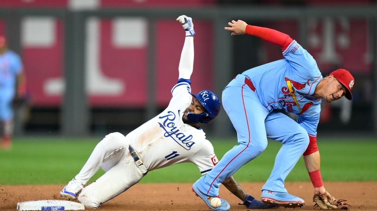 Kansas City Royals' Maikel Garcia, left, steals second ahead of...