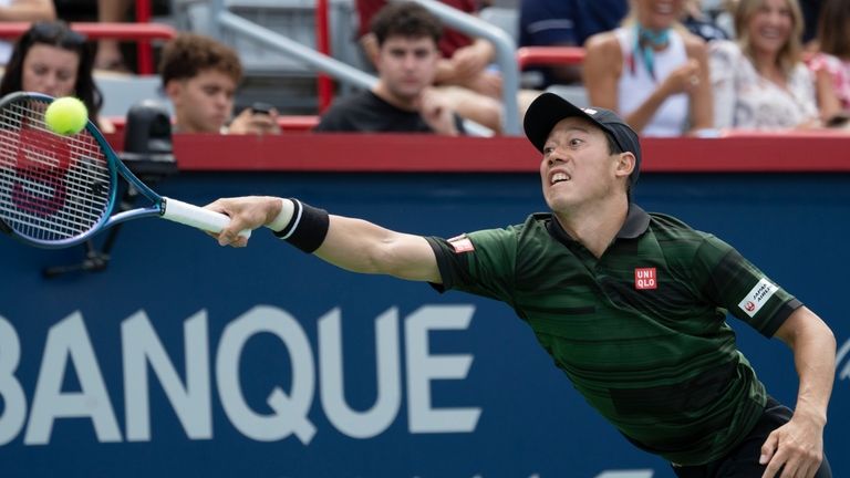 Japan's Ken Nishikori returns a shot to USA's Alex Michelsonn...