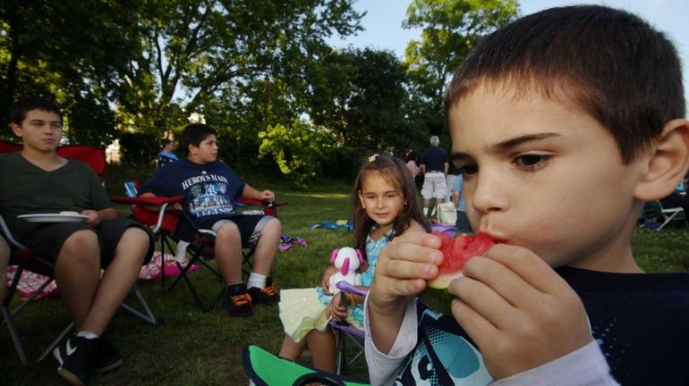 Danny Mallimo, right, 8, enjoys a little picnic with his...