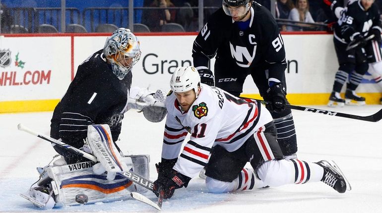 Islanders goalie Thomas Greiss makes a first-period save against Chicago's...