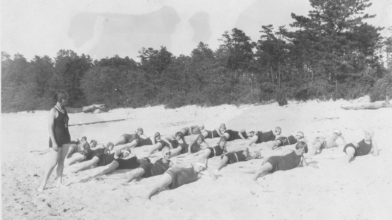 Campers stretch along the beach during the second summer of...