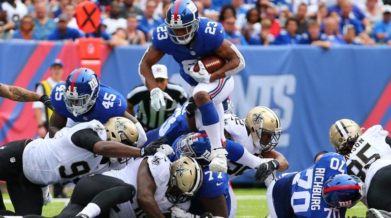 Rashad Jennings #23 of the New York Giants runs the...