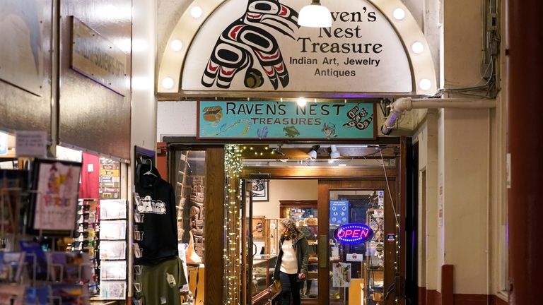 A person browses offerings in the Raven's Nest Treasure shop...