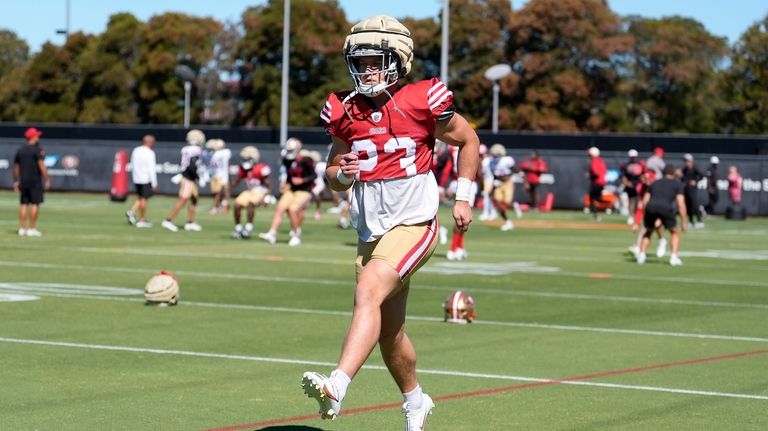 San Francisco 49ers running back Christian McCaffrey warms up during...