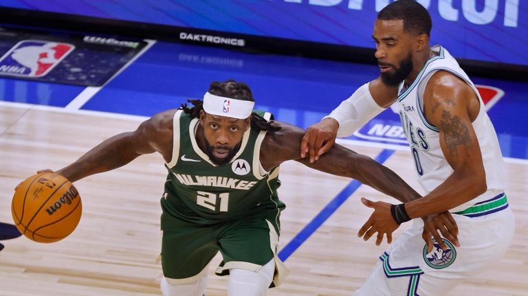 Milwaukee Bucks guard Patrick Beverley (21) works around Minnesota Timberwolves...