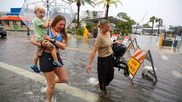 Mabrey Shaffmaster, left, carries her nephew, Arlo Hoggard, 3, left,...