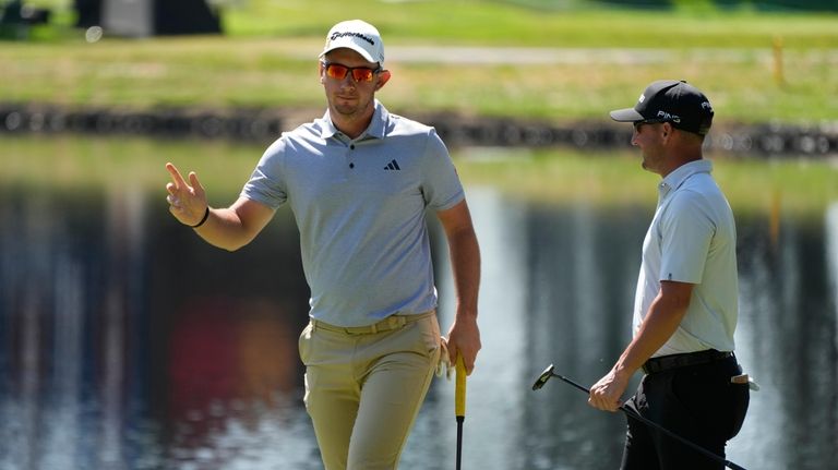 Lucas Herbert, of Australia, reacts after making a birdie putt...