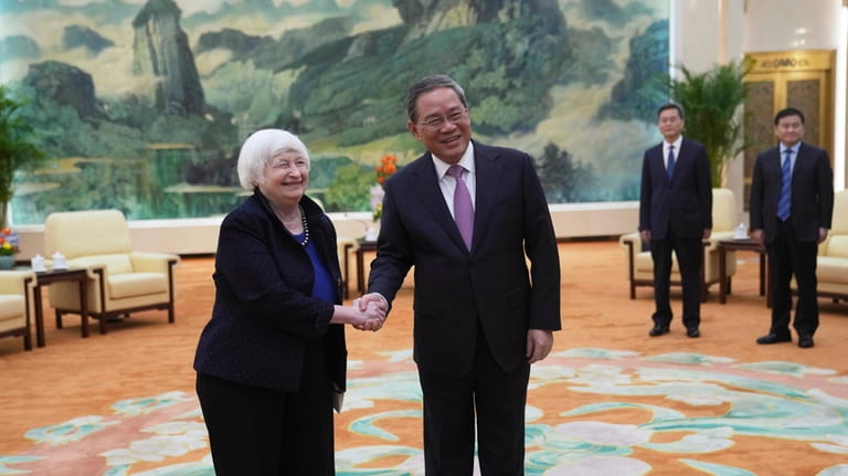U.S. Treasury Secretary Janet Yellen, left, shakes hands with Chinese...