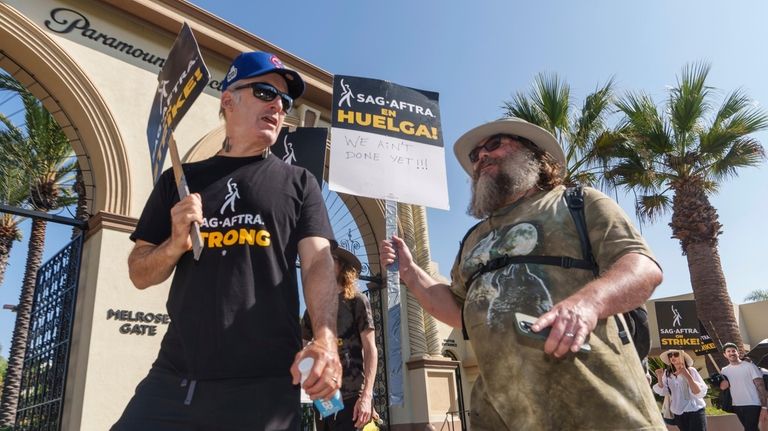 Actors Bob Odenkirk, left, and Jack Black join demonstrators outside...