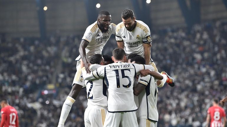 Real Madrid players celebrate scoring their first goal during the...