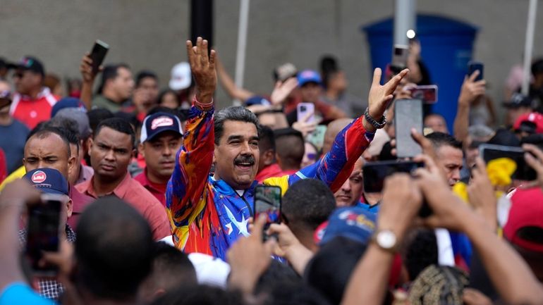 Venezuelan President Nicolas Maduro greets young supporters marching against U.S....