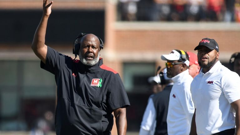 Maryland coach Mike Locksley, left, gestures during the first half...