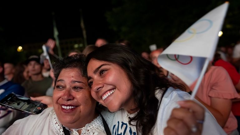 Patricia Huhem, left, and her daughter, Elisa Huhem, celebrate while...