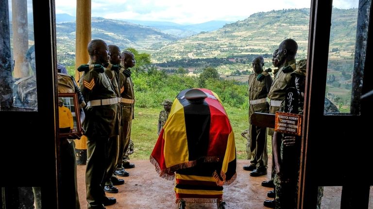 Members of Uganda People's Defence Force (UPDF) stand at the...