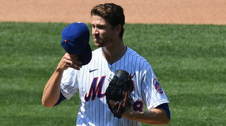 Mets starting pitcher Jacob deGrom reacts on the mound during...