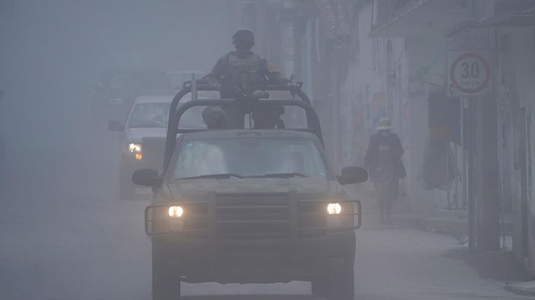 Mexican army patrols the streets as ash from the Popocatepetl...