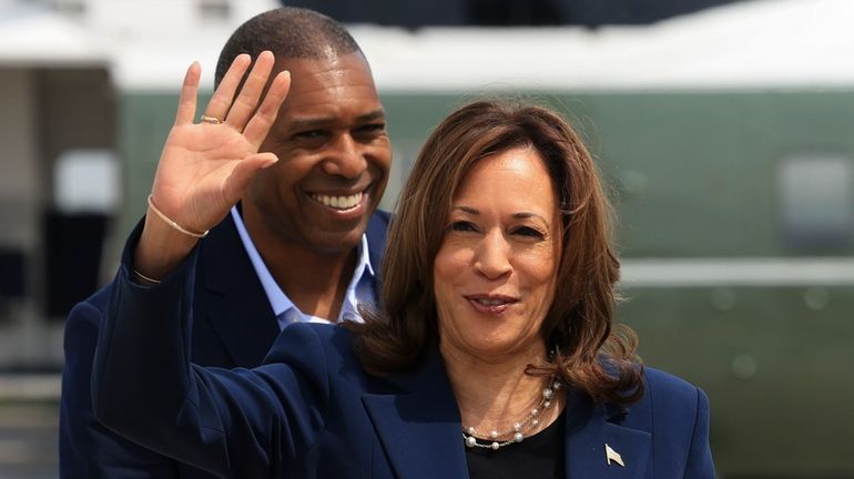 Vice President Kamala Harris waves before boarding Air Force Two...