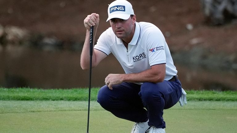 Austin Eckroat looks at his shot on the sixth green...