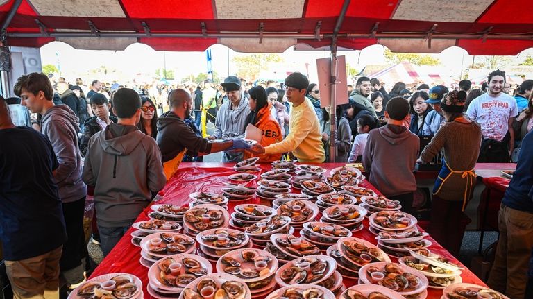 Plates of oysters are stacked for customers during the annual...