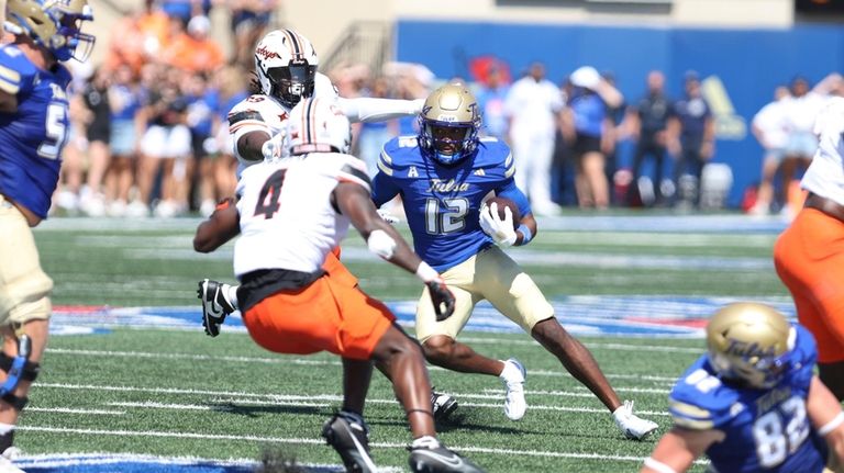 Tulsa wide receiver Corey Smith (12) looks for running room...