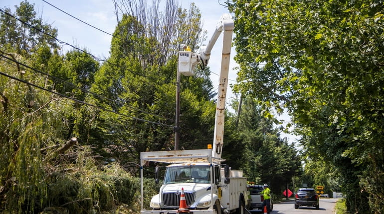 Power crews work to restore power on Potters Lane on...