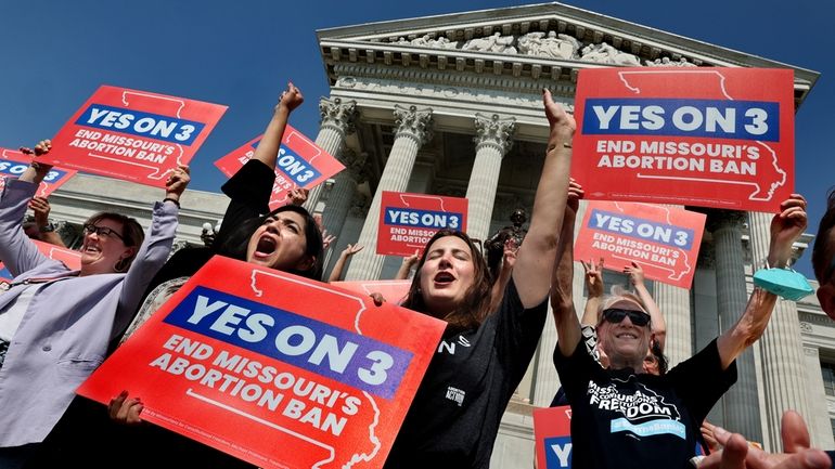 Amendment 3 supporters Luz Maria Henriquez, second from left, executive...