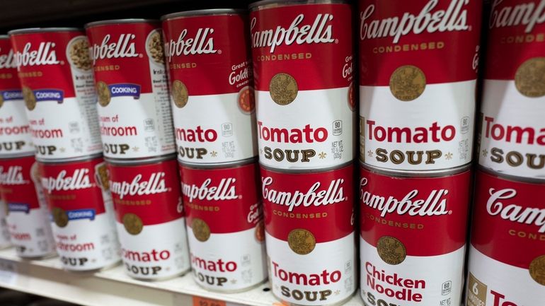 Cans of Campbell's soup are displayed in a supermarket on...