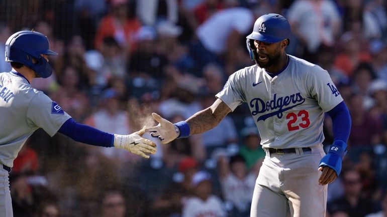 Los Angeles Dodgers' Jason Heyward, right, celebrates with Cavan Biggio...