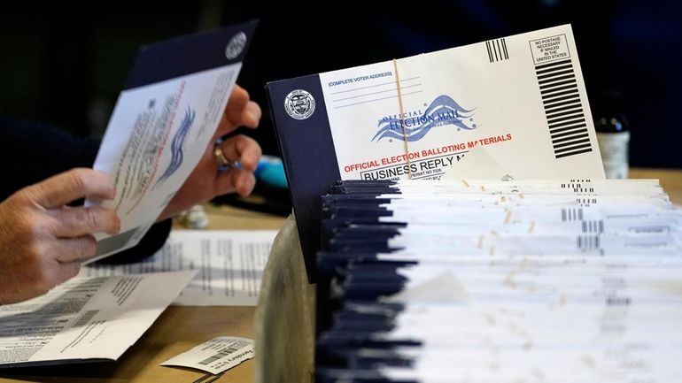 Chester County, Pa., election workers process mail-in and absentee ballots...