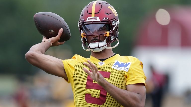 Washington Commanders quarterback Jayden Daniels throws a pass during an...