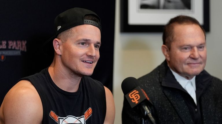 San Francisco Giants third baseman Matt Chapman, left, speaks next...