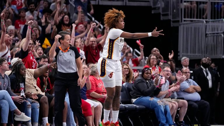 Indiana Fever forward NaLyssa Smith (1) celebrates a three-point basket...