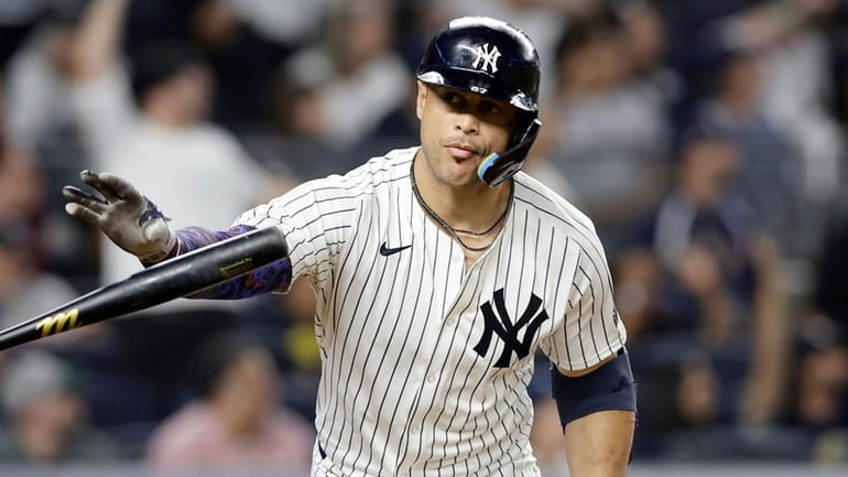 Giancarlo Stanton #27 of the Yankees reacts after his eighth inning...