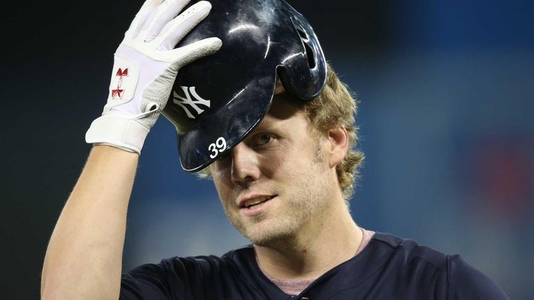 Mark Reynolds of the Yankees warms up before playing against...