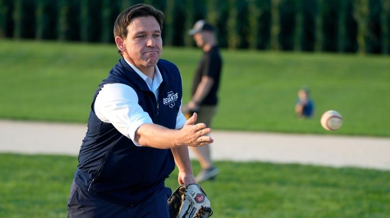 Republican presidential candidate Florida Gov. Ron DeSantis pitches a baseball...