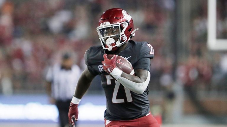 Washington State running back Wayshawn Parker (21) carries the ball...