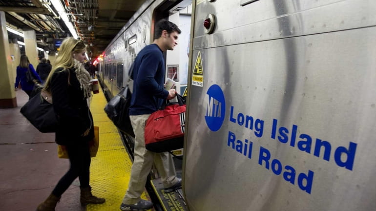 LIRR customers board a train at Penn Station on Dec....