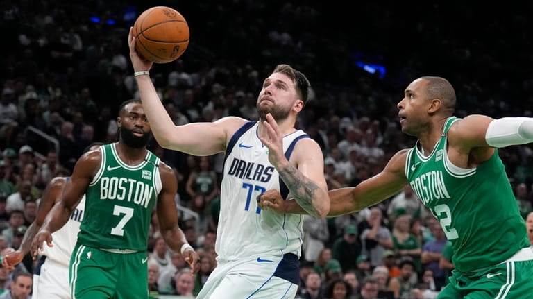 Dallas Mavericks guard Luka Doncic (77) drives as Boston Celtics...