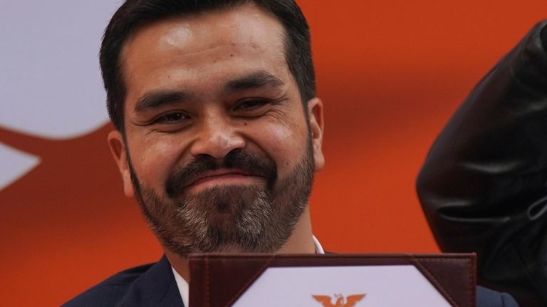 Rep. Jorge Álvarez Máynez holds his registration certificate after he...