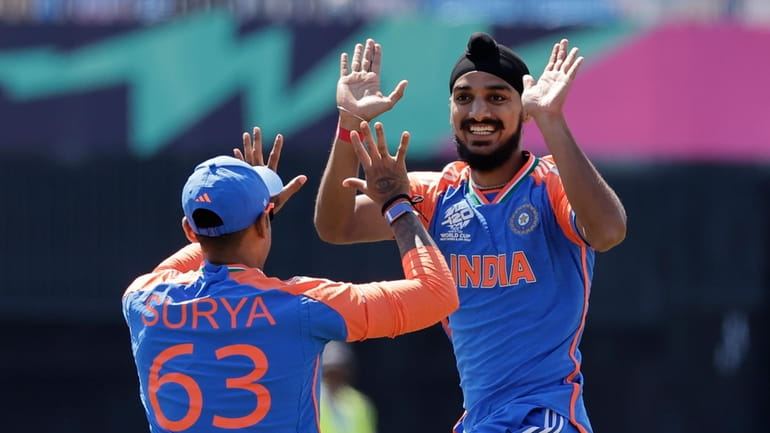 India's Arshdeep Singh, right, celebrates with teammate Suryakumar Yadav after...