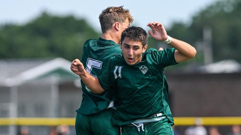 Lucas Viegas of Carle Place celebrates his goal with teammate...