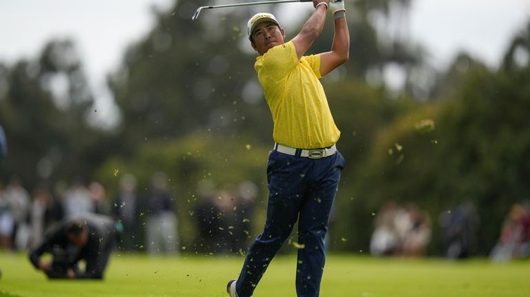 Hideki Matsuyama, of Japan, hits from the 18th fairway during...