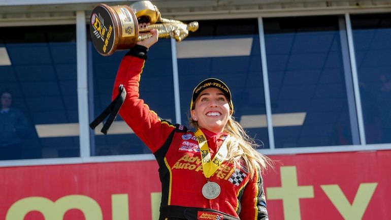 In this photo provided by the NHRA, Brittany Force celebrates...