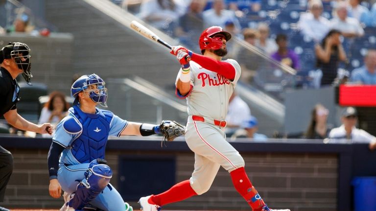 Philadelphia Phillies designated hitter Kyle Schwarber hits a solo home...