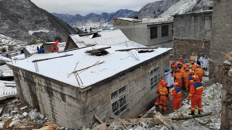 In this photo released by Xinhua News Agency, rescue workers...