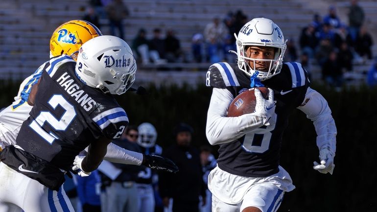 Duke's Jordan Moore (8) carries the ball during the second...