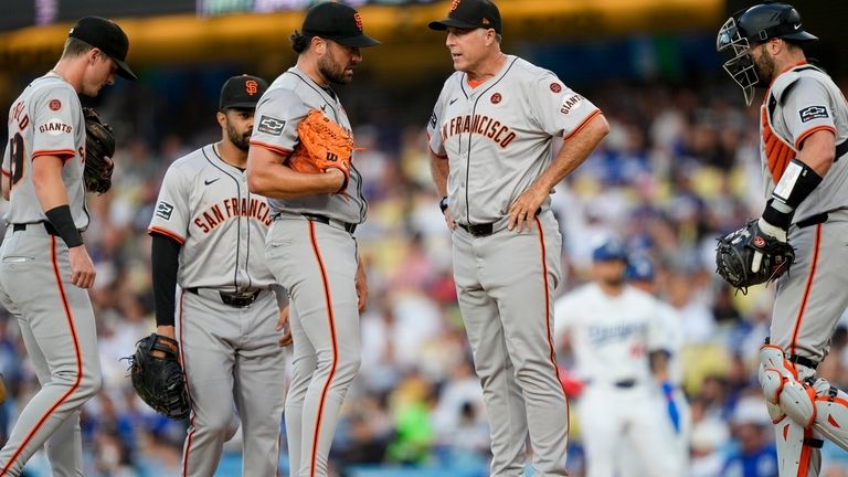 San Francisco Giants starting pitcher Robbie Ray, second from left,...