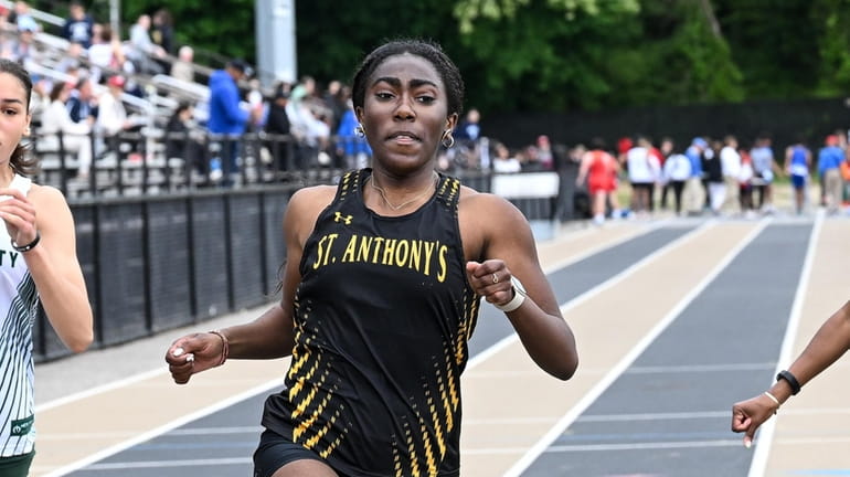 Camryn Daley of St. Anthony’s finishes first in the 100m...