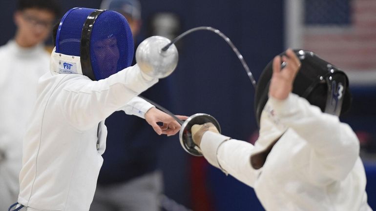 Huang Edwards of Manhasset, left, scores a touch against Jerry...